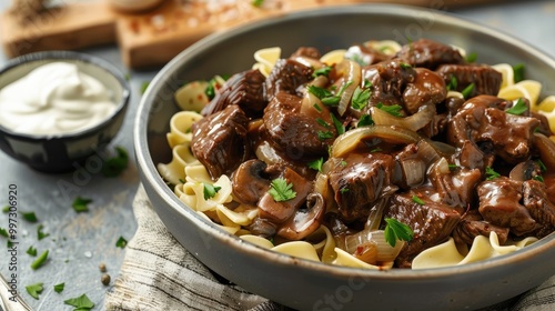 Tender beef tips with mushrooms and onions over egg noodles and sour cream