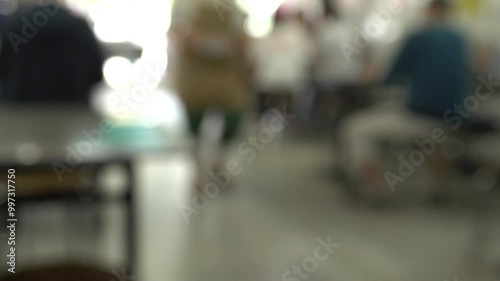 Wallpaper Mural A blurry image of a restaurant with people sitting at tables. Scene is somewhat chaotic and busy, with people sitting and standing around Torontodigital.ca