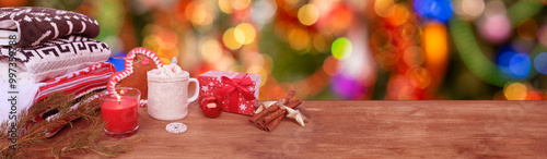 hot cocoa, wooden table, New Year's presents, stack wool sweaters, blurred colorful Christmas background panorama, christmastime Moments, Bokeh with garlands