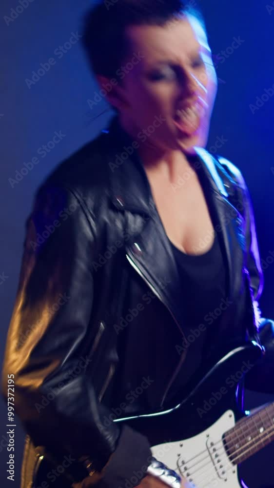 Vertical video Fierce rocker woman sings and plays bass guitar in a heavy metal concert, showing off her powerful voice and her rebellious energy. Musical talent and iconic style at live show. Camera Vertical video Fierce rocker woman sings and plays bass guitar in a heavy metal concert, showing off her powerful voice and her rebellious energy. Musical talent and iconic style at live show. Camera