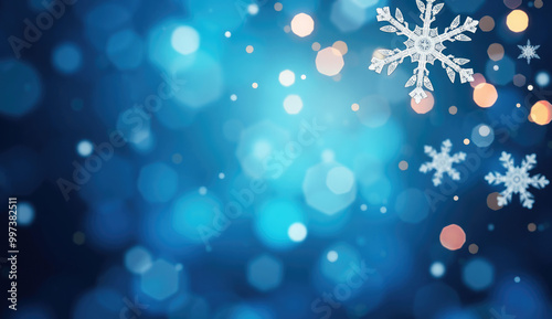 Abstract winter background with snowflakes on a vibrant blue bokeh backdrop.