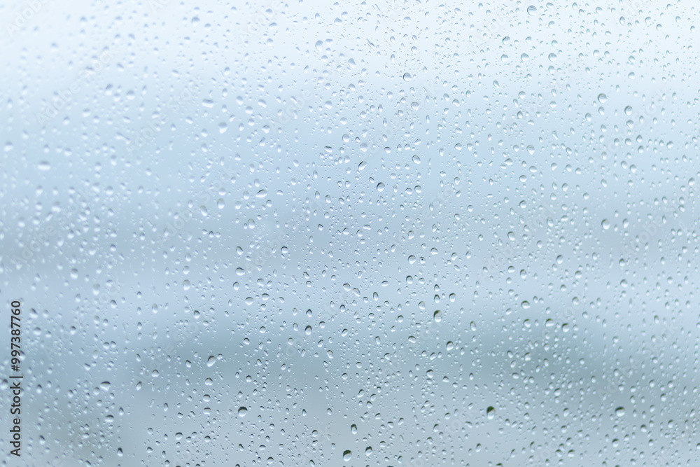 Raindrops on a windowpane create a serene atmosphere during a cloudy day Raindrops on a windowpane create a serene atmosphere during a cloudy day
