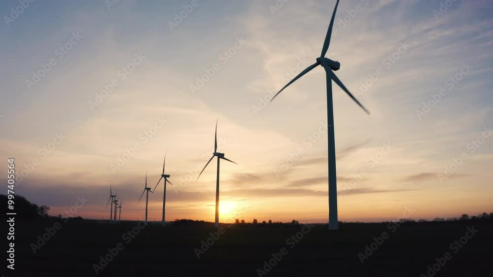 Wind Turbines Spin Silently Over The Wheat Fields Of Gdansk, Poland, As The Sun Sets, Creating A Picture-Perfect Scene Of Clean Energy Production. Wind Turbines Spin Silently Over The Wheat Fields Of Gdansk, Poland, As The Sun Sets, Creating A Picture-Perfect Scene Of Clean Energy Production.