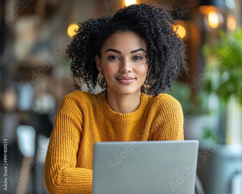 African American woman using laptop to manage multiple tasks and projects photo