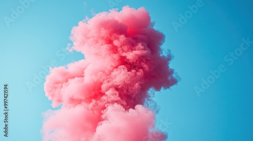 A vibrant pink smoke cloud against a clear blue sky, creating an artistic visual effect.