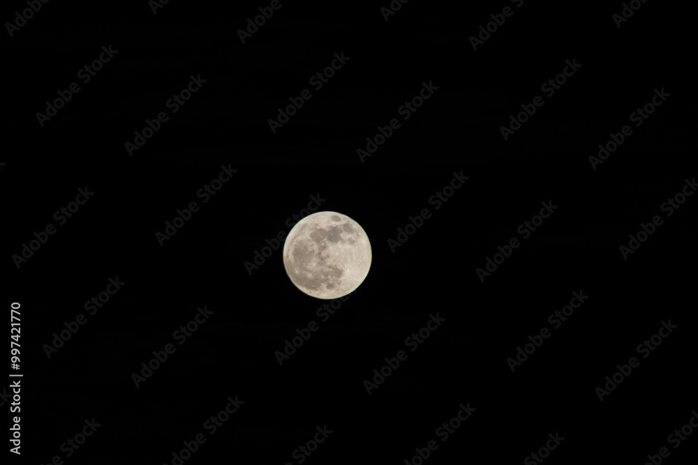 Full moon in the night sky, closeup of the moon. Full moon in the night sky, closeup of the moon.