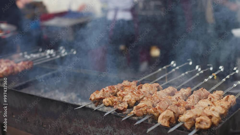 Food festival with food stall kiosk, open-air outdoor fair market, assortment of different traditional European grilled barbecued street food with sausages, bbq, chicken, pork and lamb on a large pan