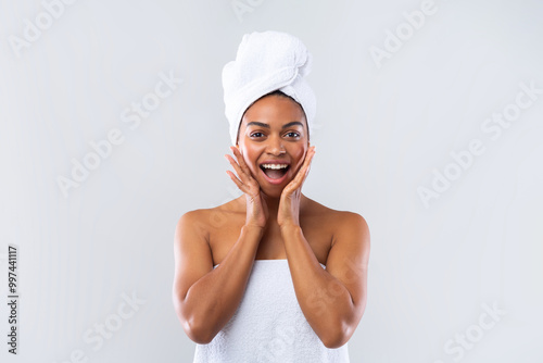 Excited young black lady wrapped in towel expressing amazement over grey background, amazing deals for beauty procedures