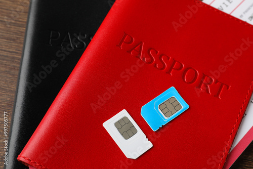 Passports and SIM cards on wooden table