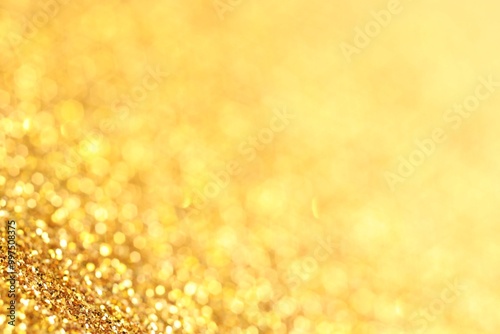 Beautiful shiny golden glitter as background, closeup
