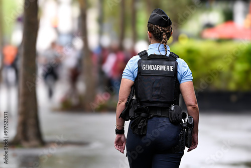 Fototapeta Naklejka Na Ścianę i Meble -  Illustration picture showing a female police officer (woman) with uniform from gendarmerie ensuring security in Paris, France on September 26, 2024. French national policewoman in action.