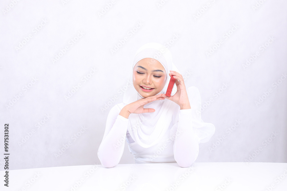 closeup makeup lips Beautiful young hijab ladies asia laughing close eyes hands holding lipstick container and touching chin isolated white background. cosmetics concept, lipstick container mock up closeup makeup lips Beautiful young hijab ladies asia laughing close eyes hands holding lipstick container and touching chin isolated white background. cosmetics concept, lipstick container mock up