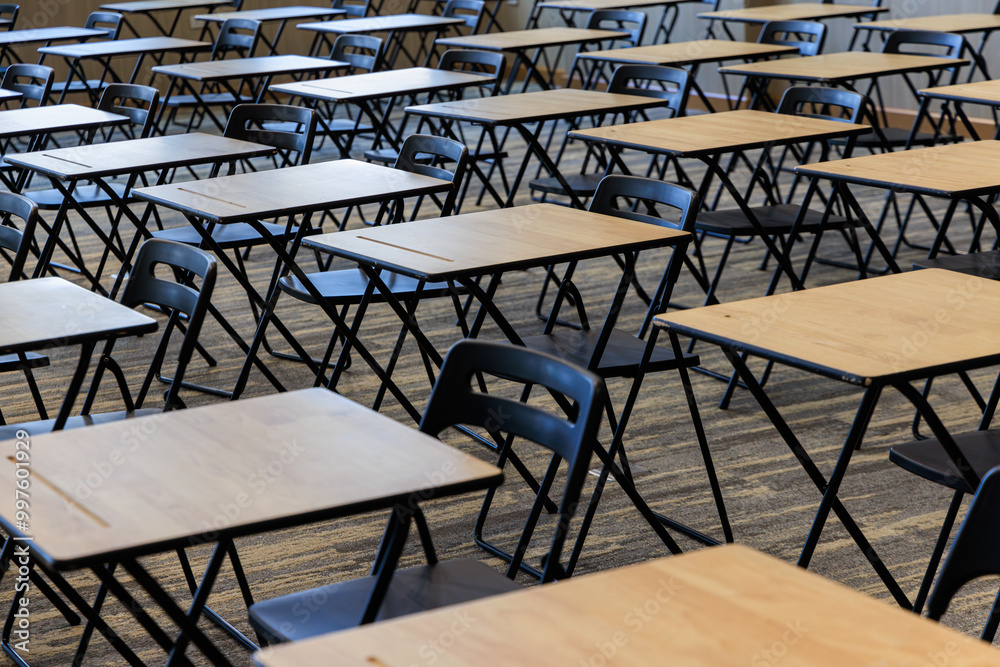 Fototapeta premium classroom with many empty desks and chairs. The room is empty and quiet