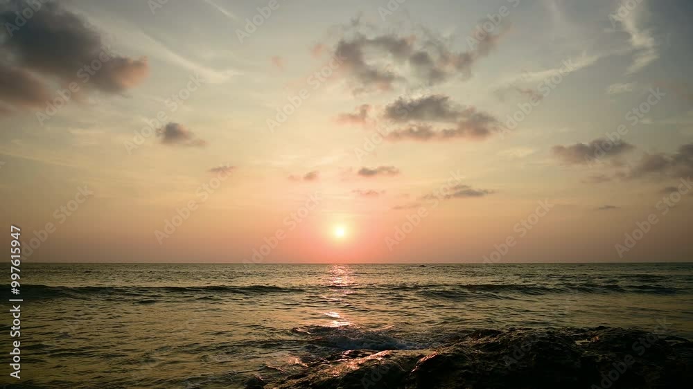 Dramatic sunset with orange sky in a cloudy day at a tropical beach. Dramatic sunset with orange sky in a cloudy day at a tropical beach.