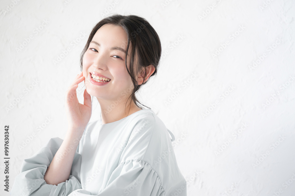 Cute woman looking at camera touching skin For beauty and beauty Copy space on the right Cute woman looking at camera touching skin For beauty and beauty Copy space on the right