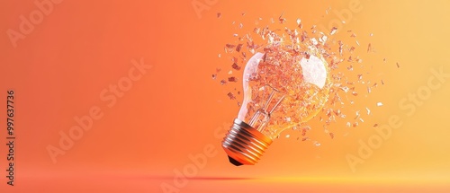 Shattered light bulb with glass shards, orange background.