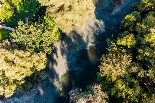 Aerial view of polluted riverbed, sewage discharge into river