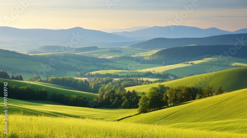 Rolling Green Hills and Distant Mountains at Dawn