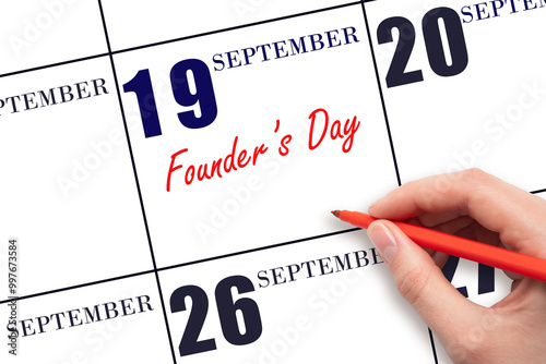 September 19. Hand writing text Founder's Day on calendar date. Save the date. photo