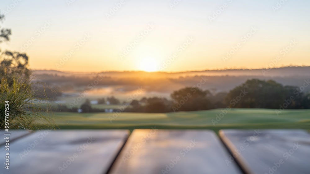 Fototapeta premium The wooden table offers a tranquil view of the golf course at sunrise, capturing the beauty of the dawn light across the landscape