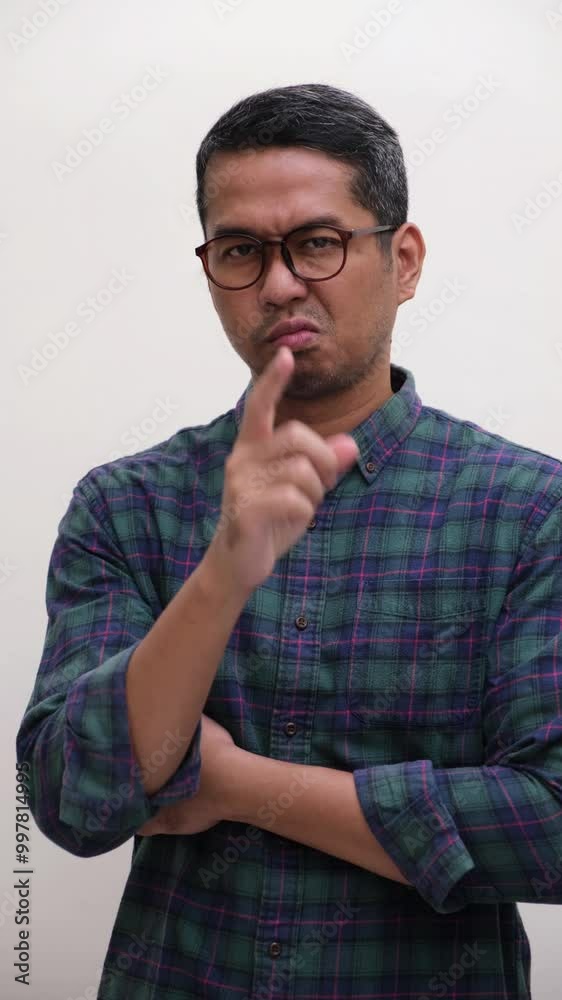 A man showing cynical face and pointing at the camera A man showing cynical face and pointing at the camera