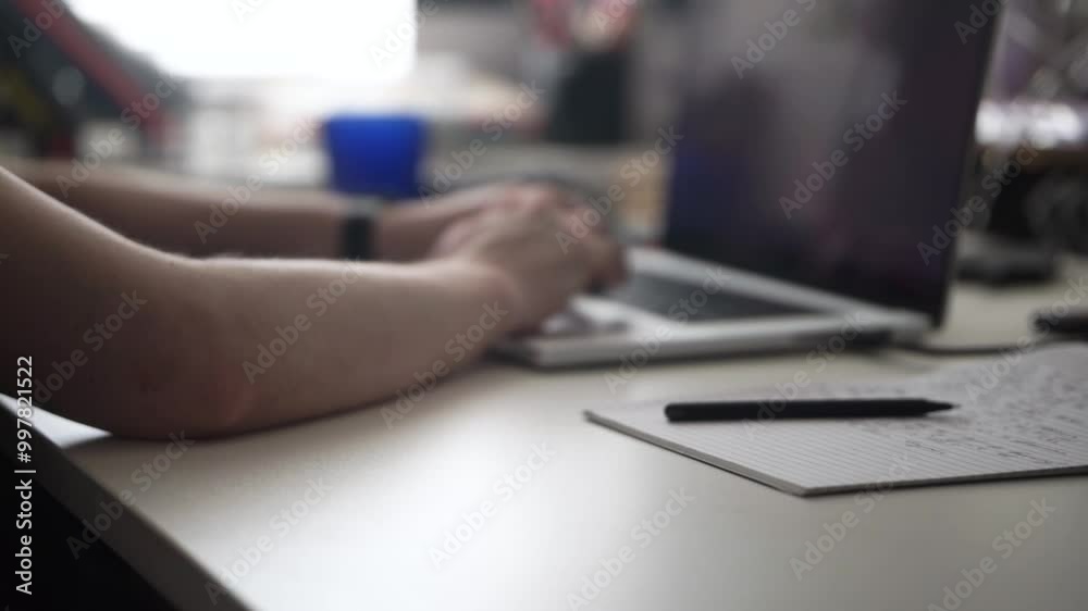 Man Writing Ideas While Working on Laptop Man Writing Ideas While Working on Laptop