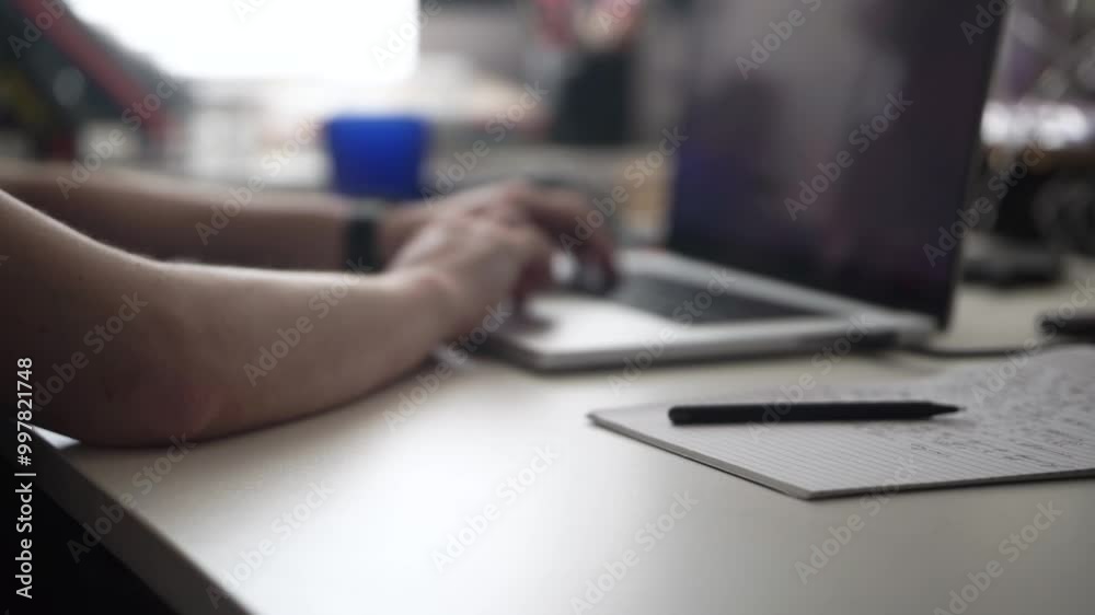 Man Writing Ideas While Working on Laptop Man Writing Ideas While Working on Laptop