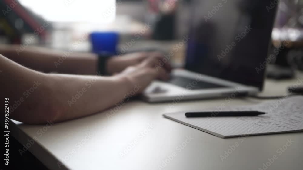 Man Writing Ideas While Working on Laptop Man Writing Ideas While Working on Laptop