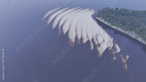 Drone descends on Praia do Meio from the west side of Rio Negro river in Novo Airão, Amazonas, Brazil photo