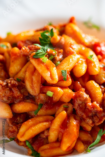 Primo piano di cavatelli campani conditi con sugo di salsiccia di maiale, pasta italiana  photo