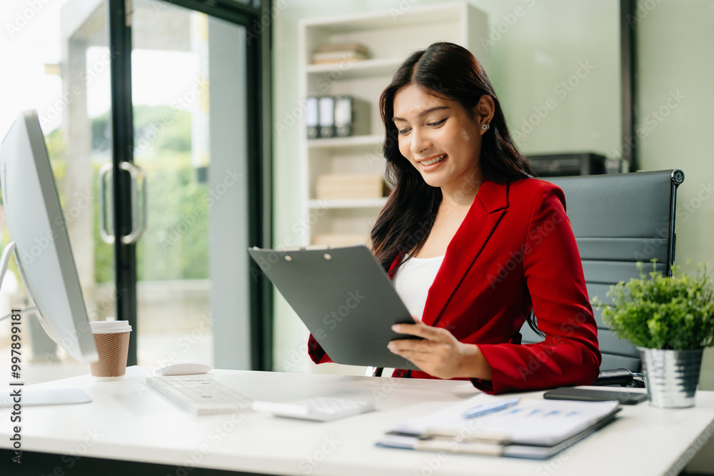 Young businesswoman working with working notepad, tablet and laptop documents talking on the smartphone, tablet Young businesswoman working with working notepad, tablet and laptop documents talking on the smartphone, tablet