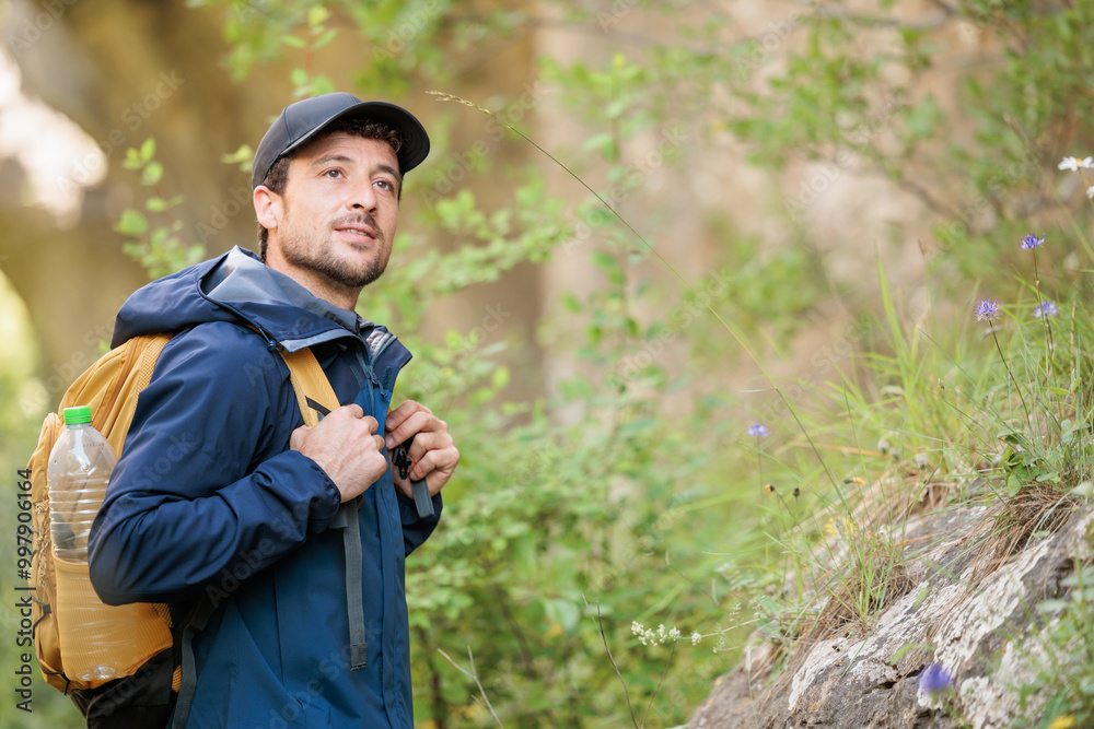 Young man enjoying nature.Hiking in the mountains, observing the landscape.Doing sports and physical activity.Let's take care of our natural surroundings and our environment.Moments of disconnection Young man enjoying nature.Hiking in the mountains, observing the landscape.Doing sports and physical activity.Let's take care of our natural surroundings and our environment.Moments of disconnection