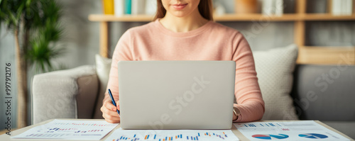 Businesswoman at home office, engaged in data analysis, strategizing with charts and notes, focused on company growth and planning. photo