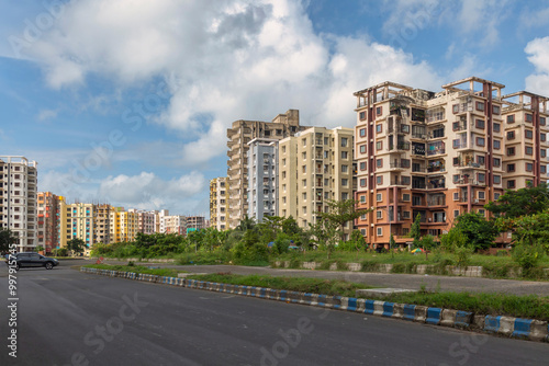 Fototapeta Naklejka Na Ścianę i Meble -  Residential multistory apartment buildings with view of city road at Rajarhat area at Kolkata, India.	