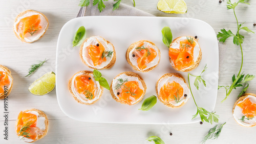 Obraz na płótnie Assorted toasts with cream cheese, salmon, and smoked salmon. Ideal for buffet, catering, and healthy meal options, top view w salonie