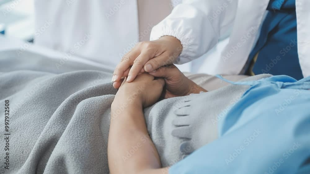 Women Asian doctors hold the patient hand and encourage and provide medical advice While checking the patient health in bed. Concept of Care and compassion, antenatal care, Threatened abortion Women Asian doctors hold the patient hand and encourage and provide medical advice While checking the patient health in bed. Concept of Care and compassion, antenatal care, Threatened abortion