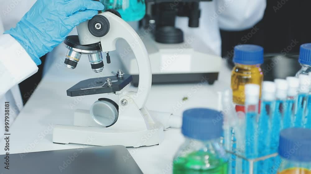 Scientist adjusting microscope, conducting research in a modern laboratory. The lab is equipped with advanced technology, reflecting the cutting edge nature of her work Scientist adjusting microscope, conducting research in a modern laboratory. The lab is equipped with advanced technology, reflecting the cutting edge nature of her work