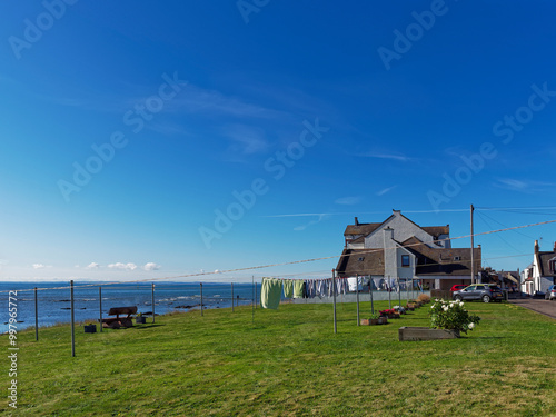 The new build apartments at the water edge of Seagate and Shore End, with a Drying Green with washing hanging on the clothes lines in the sun,