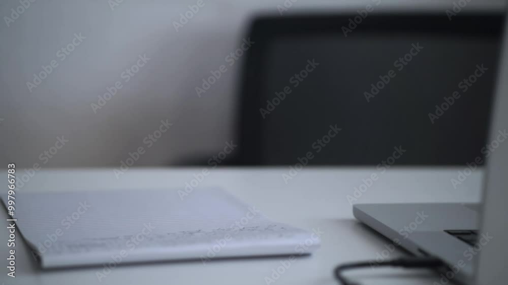 Man Working on Laptop and Taking Notes in Notebook Man Working on Laptop and Taking Notes in Notebook
