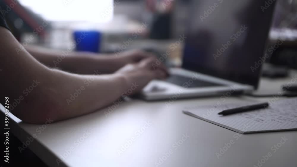 Man Working on Laptop and Taking Notes in Notebook Man Working on Laptop and Taking Notes in Notebook
