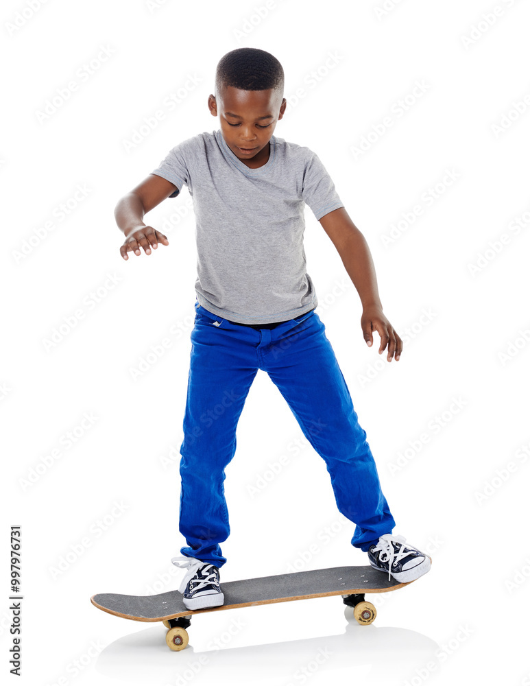 Studio, trick and boy with skateboard for riding, training and practice for game. Mockup space, skater and black child with sports equipment for playing, coordination and ready by white background Studio, trick and boy with skateboard for riding, training and practice for game. Mockup space, skater and black child with sports equipment for playing, coordination and ready by white background