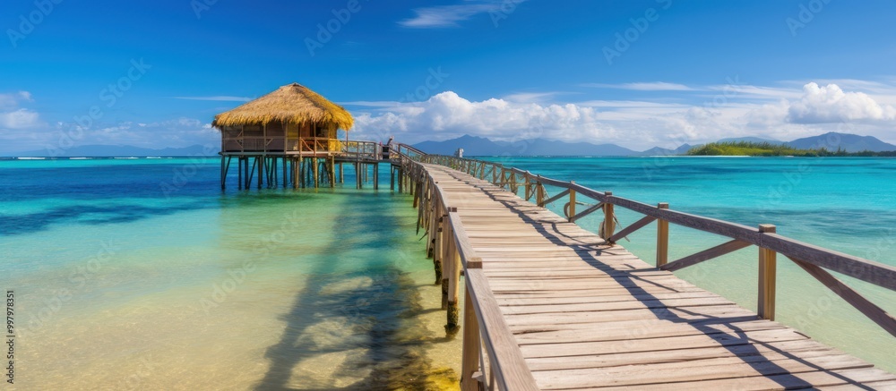 Wooden Pier Leading to a Tropical Bungalow on Stilts Wooden Pier Leading to a Tropical Bungalow on Stilts