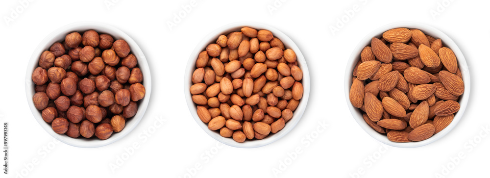 Bowl plates with hazelnut and almonds and peanut nuts isolated on white background.Top view. Bowl plates with hazelnut and almonds and peanut nuts isolated on white background.Top view.