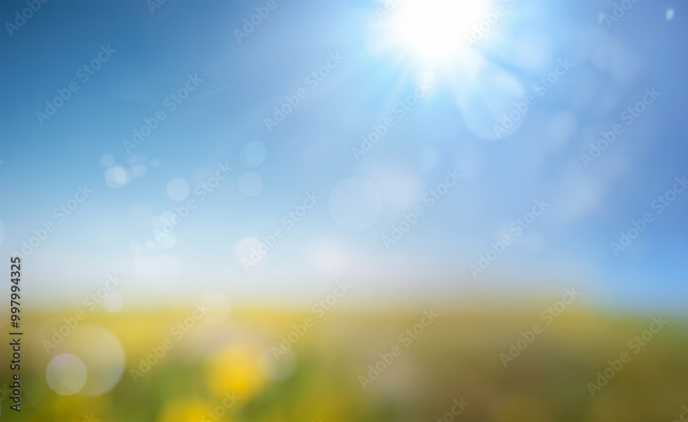 Fototapeta premium Fresh spring blue sunny sky background with a blurred, warm and sunny glow.
