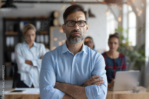 photo capturing a frustrated businessman during a heated argument with his diverse team in the office.