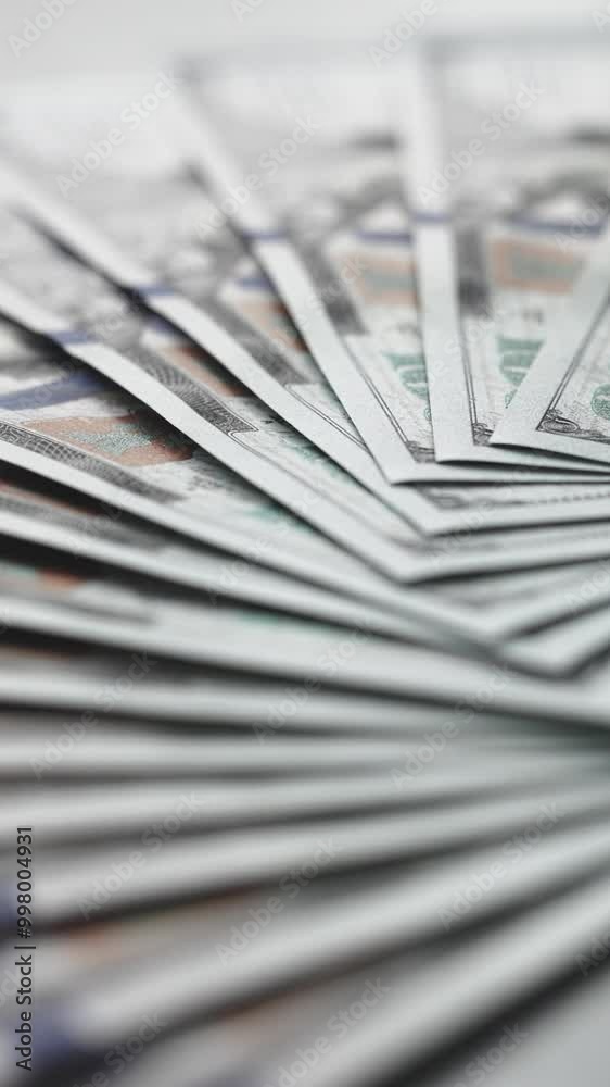Vertical video. American cash dollars close up. A large amount of cash American dollars in cash paper bills. Vertical video. American cash dollars close up. A large amount of cash American dollars in cash paper bills.