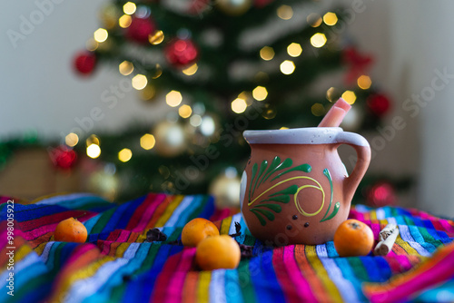 Photos Typical Mexican Christmas punch on colorful serape with Christmas tree in the background