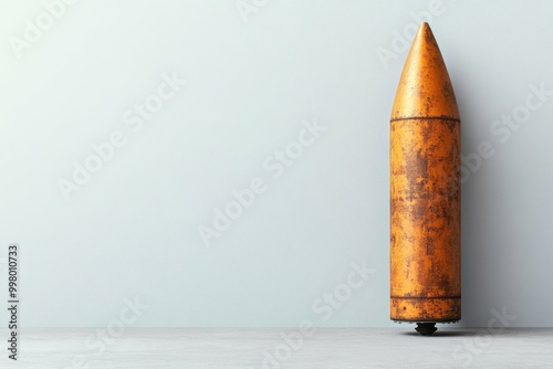 A decommissioned nuclear warhead inert laying on a simple matte surface showing fine details of its casing. photo