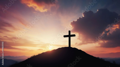 Silhouette of crucifix on hilltop against sunset sky symbolizes faith and belief in God