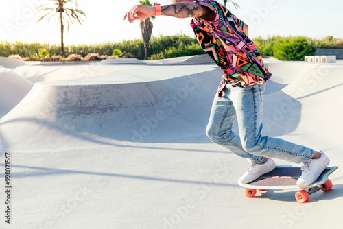 unrecognizable stylish skater in jeans and sneakers practicing skills with skateboard in skatepark on sunny day in summer photo